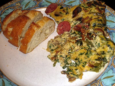 Mustard, cheese and sausage quiche with bread fresh from the oven, a dish to gladden any heart.