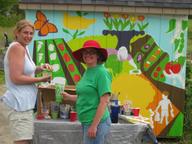 Marcia, Suz with mural nearing completion