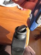 gently prying the cover off the knob with a knife blade