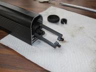 bottom of latch assembly showing stem protruding enough for convenient assembly but not far enough to slip out of its channel at top